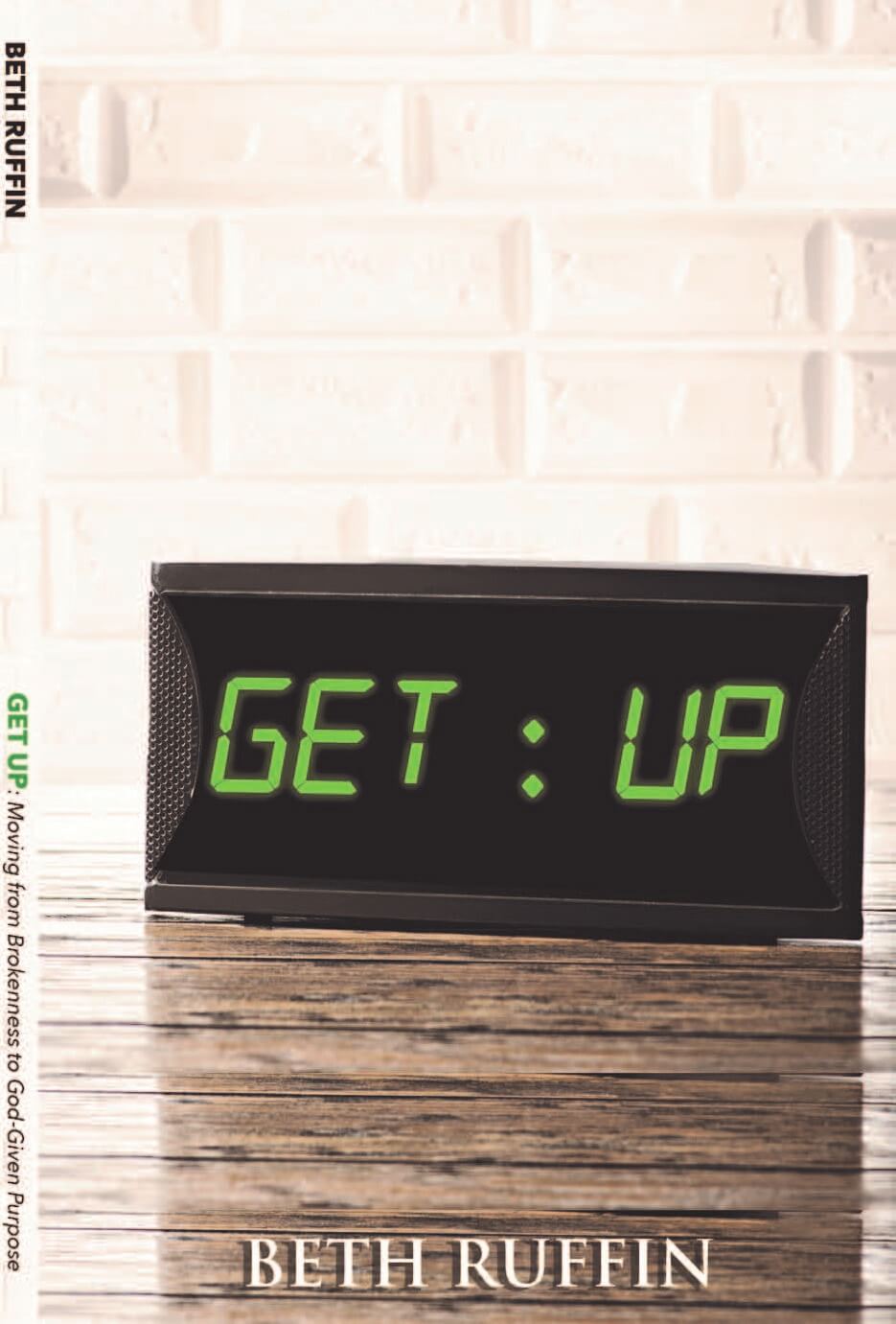 A book titled "GET UP: Moving from Brokenness to God-Given Purpose" by Beth Ruffin, with a digital alarm clock design.